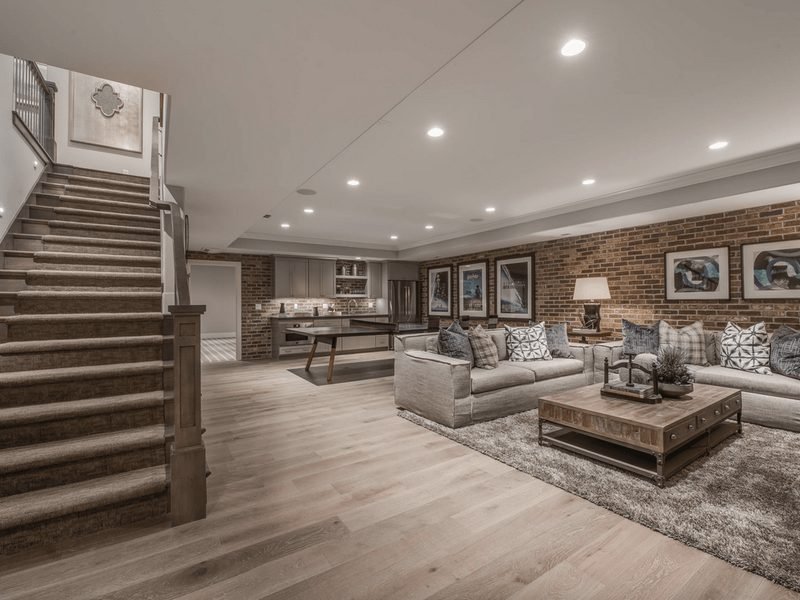Finished basement with brick accent wall
